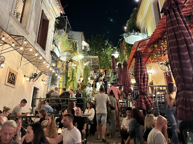 busy street night with restaurants in greece