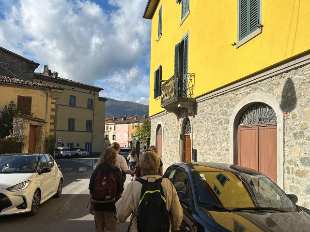 walking in town italy yellow house
