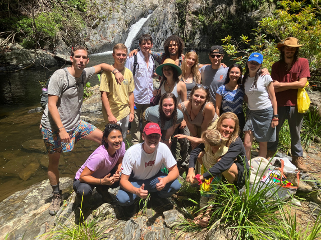 group photo posing in front of waterfall