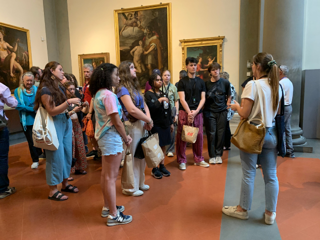 students listening on a museum tour