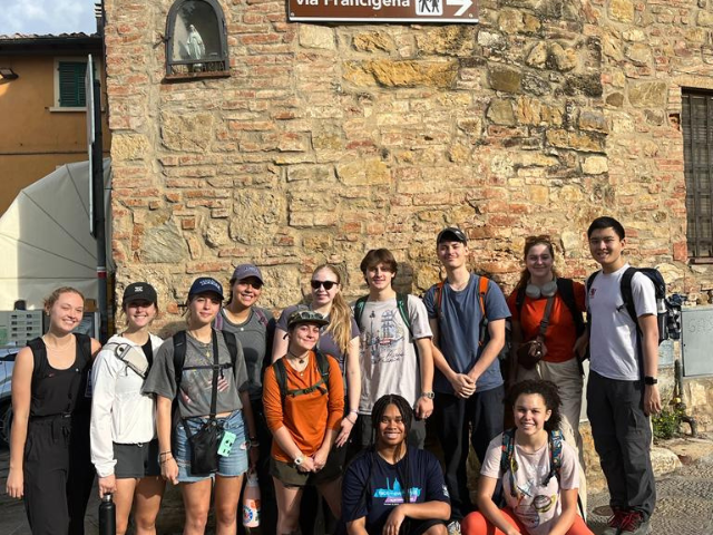 students posing group photo during trek across tuscany