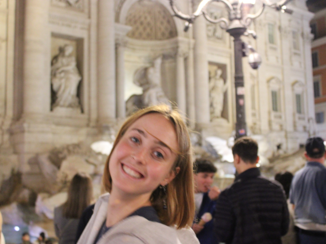 student smiling at the Trevi fountain