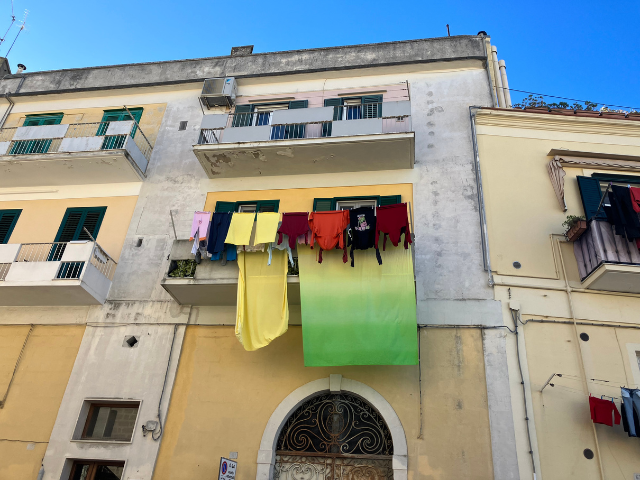 clothesline in matera colorful green sheet