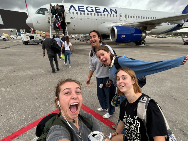students boarding plane to greece
