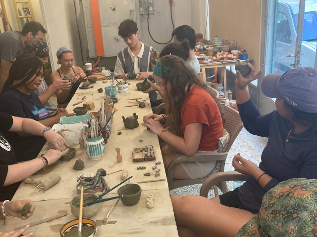 students taking a pottery class