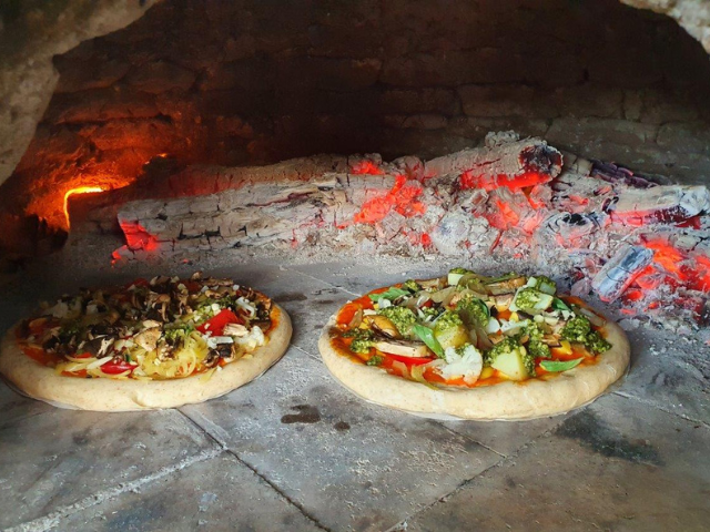 cooking pizzas in the wood fired