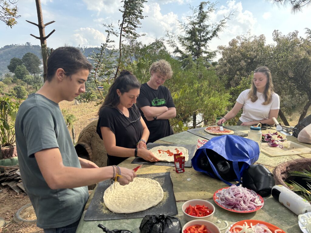 students learning how to make pizza together