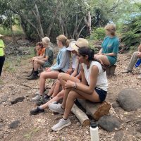 The group doing vocal exercises and starting to learn a traditional Hawaiian chant.